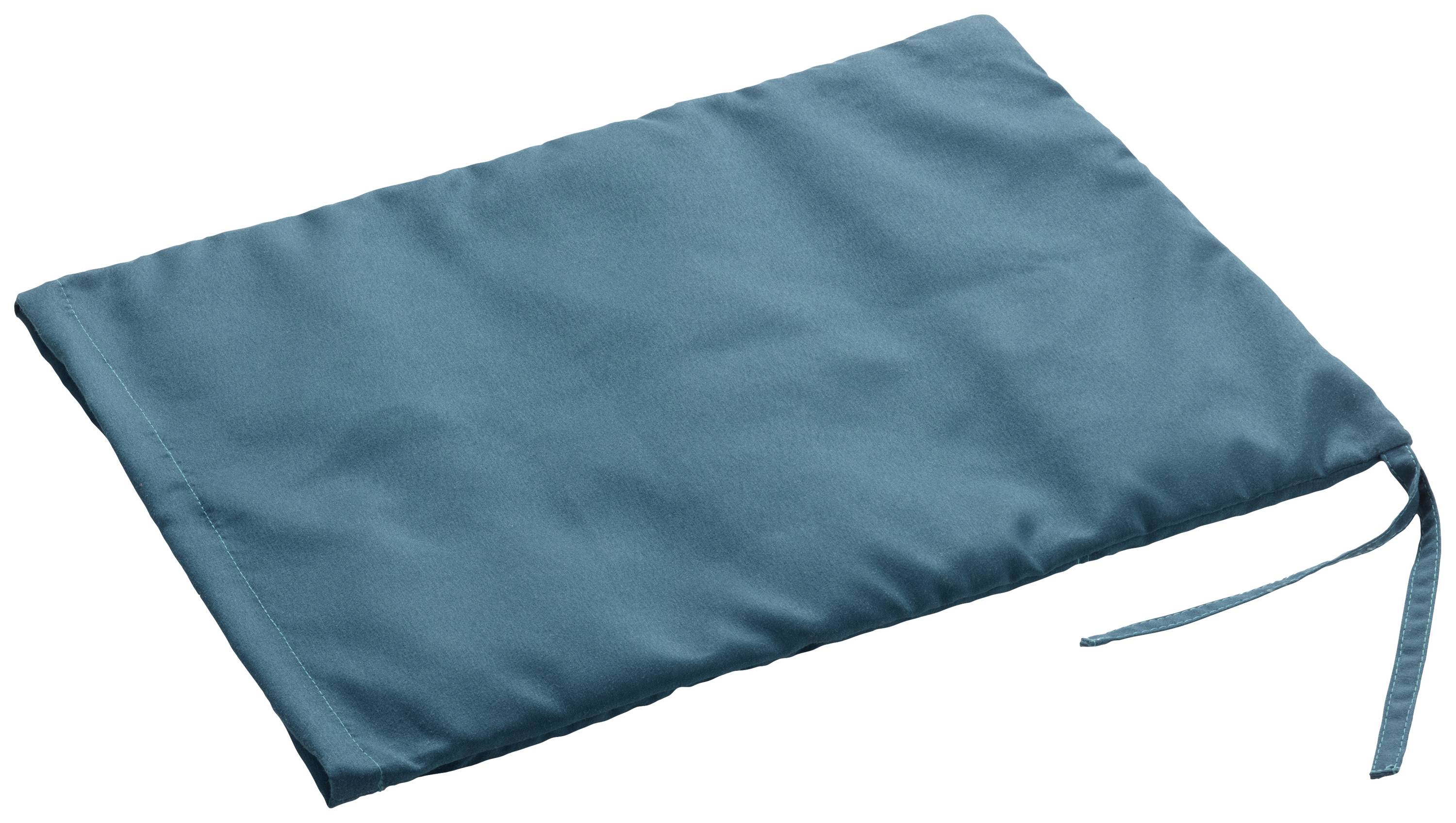A turquoise, rectangular textile cushion with a ribbon on the right side lies flat on a white surface.