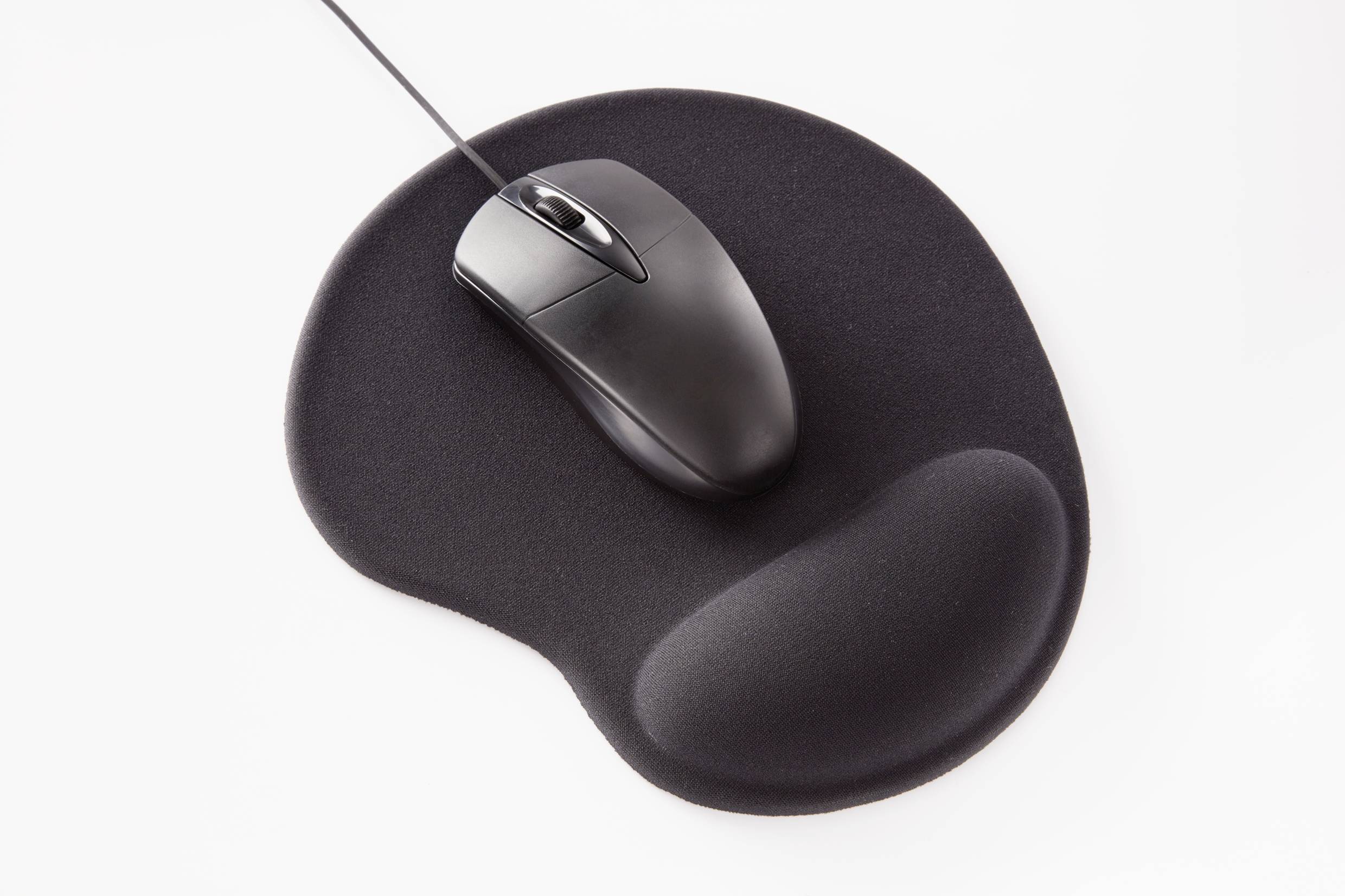 A black computer mouse is resting on an ergonomic mousepad with a wrist rest.