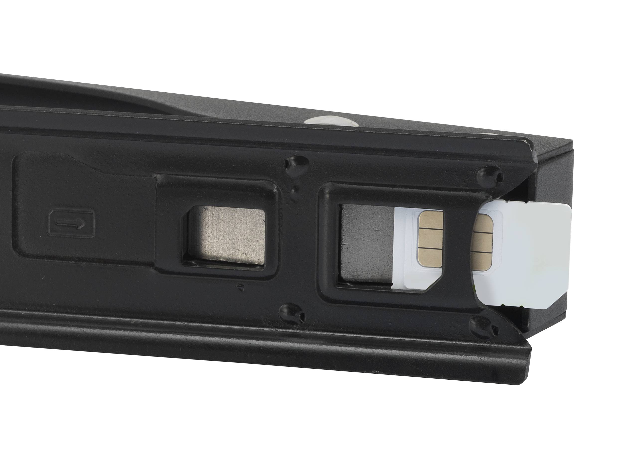 Close-up of a slot in a device where a SIM card is being inserted. The SIM card is partially visible.