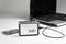 Cassette player by 'renkforce', connected to a laptop. A cassette is placed beside it. The laptop is switched on.