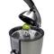 Electric citrus juicer with half a lime on the pressing cone, the lid held slightly open.
