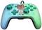 A turquoise, wired games controller with an animal motif printed in the centre, decorated with figures and leaves.