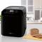 Black bread maker on kitchen worktop with chopping board and sliced bread in the foreground.