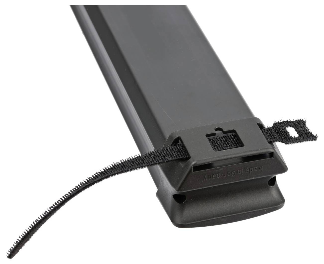 Black cable management raceway with a Velcro strap looped through a mounting bracket to secure wires.