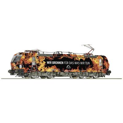 A locomotive with a vibrant flame design and the slogan 'We're passionate about what we do' on the side.