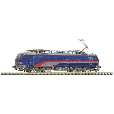 A blue model train in the design of the night train 'Nightjet', with a red stripe and star pattern on a section of track.