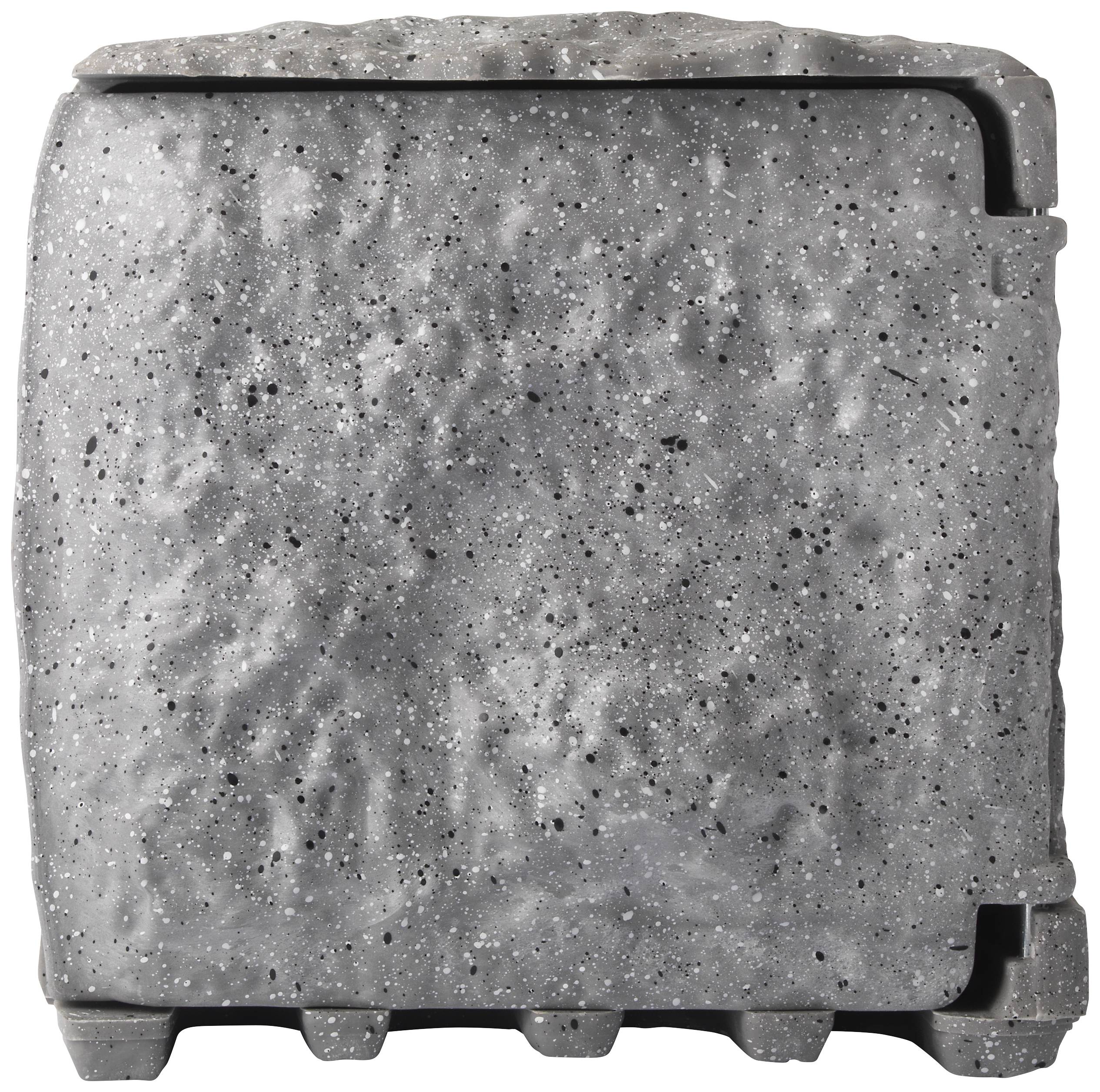 Large grey concrete block with an uneven surface, rectangular in shape, with a vertical groove on the right side.