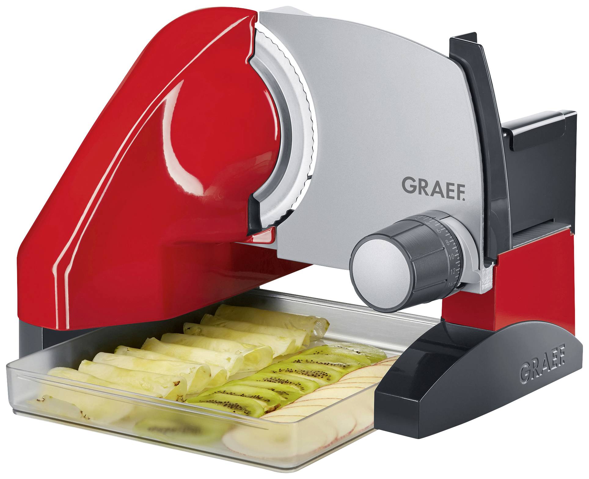 An electric slicing machine in red and silver cuts fruit slices over a collection tray.