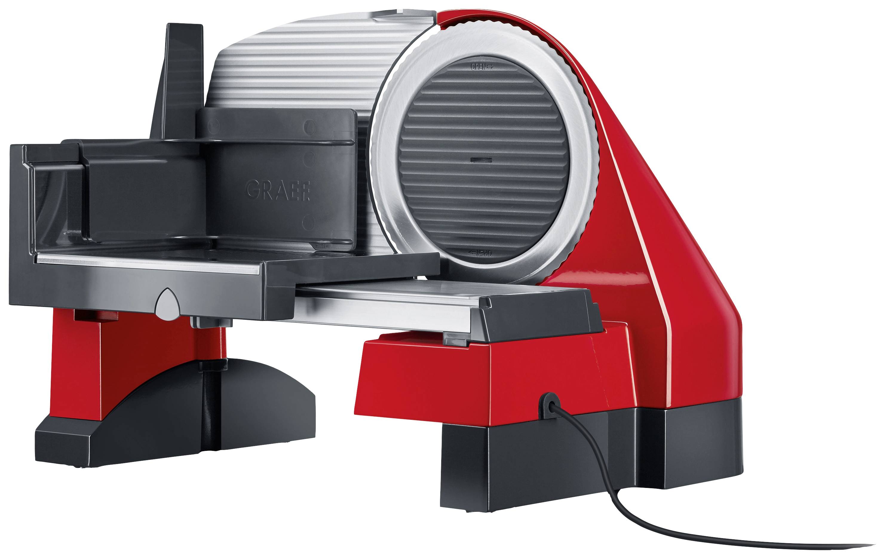A red and black electric slicing machine with a silver blade, placed on a table.