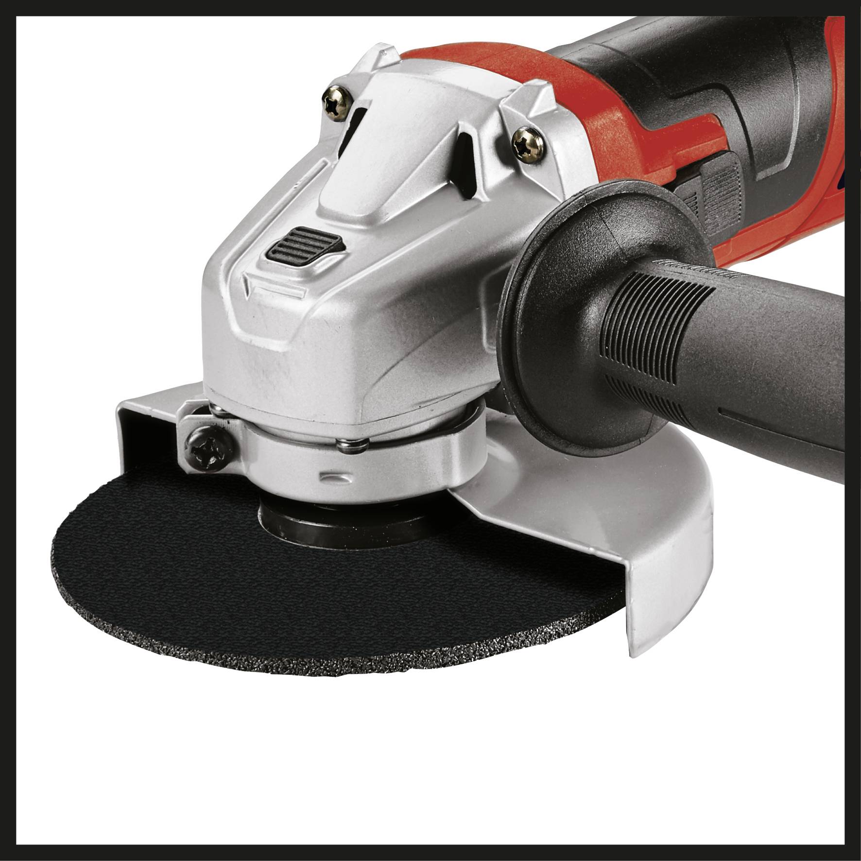 An angle grinder with a red and silver casing and a black handle. It has a black grinding disc mounted.