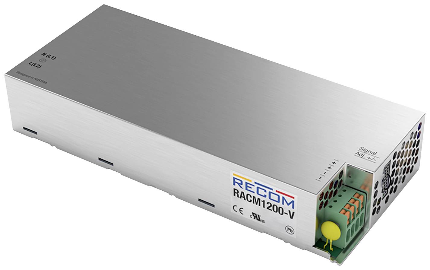 A rectangular metal enclosure of a power supply unit with the inscription 'RECOM RACM1200-V', ventilation slots and several terminal blocks.