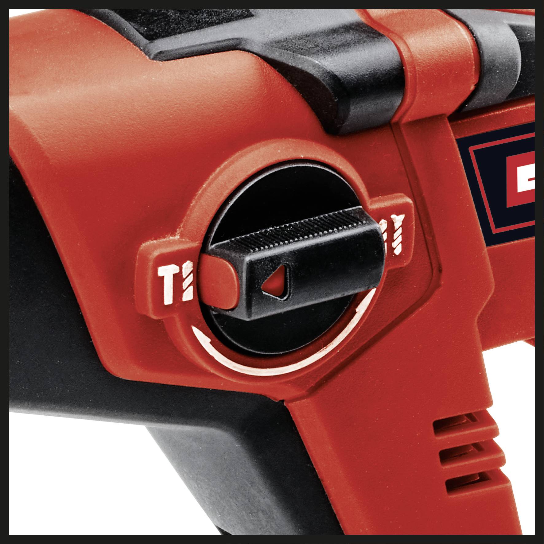 Red switch on an electric tool with settings for different operating modes, indicated by symbols.