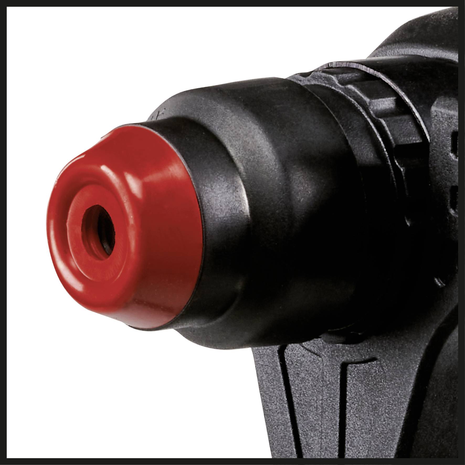 A red and black drill chuck of an electric drill, close-up.