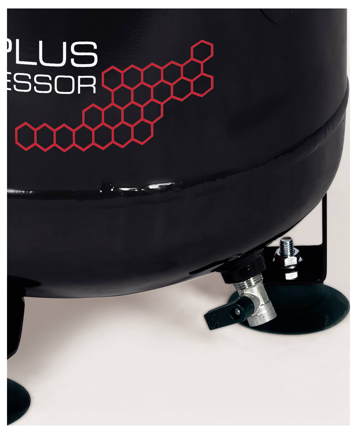 Close-up of a black compressor tank with red hexagon pattern, mounted on rubber feet and a visible valve fitting.