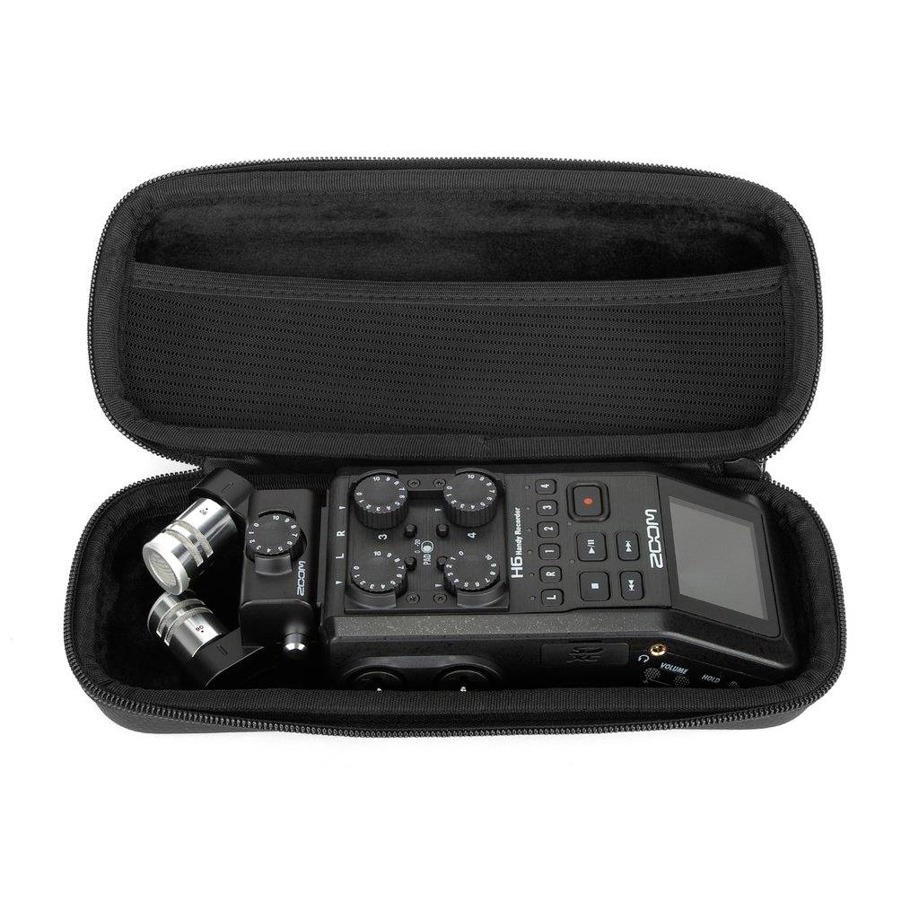 A compact audio recorder with microphone capsules and controls in an open protective case.