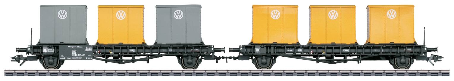Train model: Two goods wagons with VW transport containers, two grey and two orange, standing on a track. Transport or collector's item.