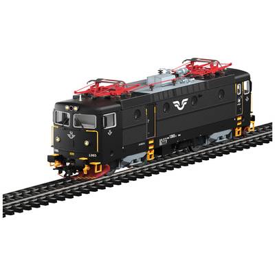 A black model of an electric locomotive with red details is travelling on a model railway track. The model number and logo are visible.