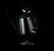 'Black kettle with lifted lid and steam outlet, against a black background. Modern design style.'