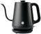 Black electric kettle with curved spout and handle, standing on a round base. 'Wilfa' brand name visible.