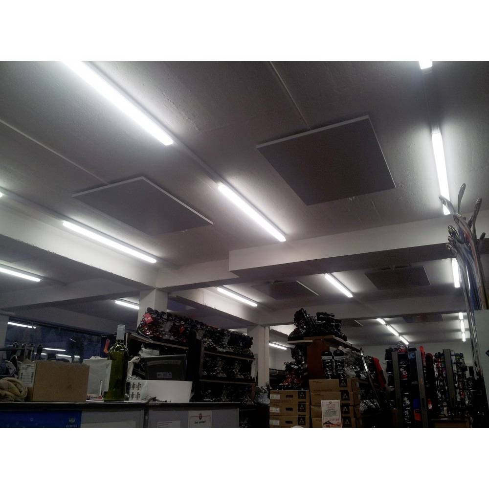 Interior of a shop with illuminated ceiling, shelves stacked with merchandise crates, boxes piled up, bright neon lighting.