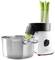 A white juicer crushes celery stalks, which fall into a pot standing next to it.
