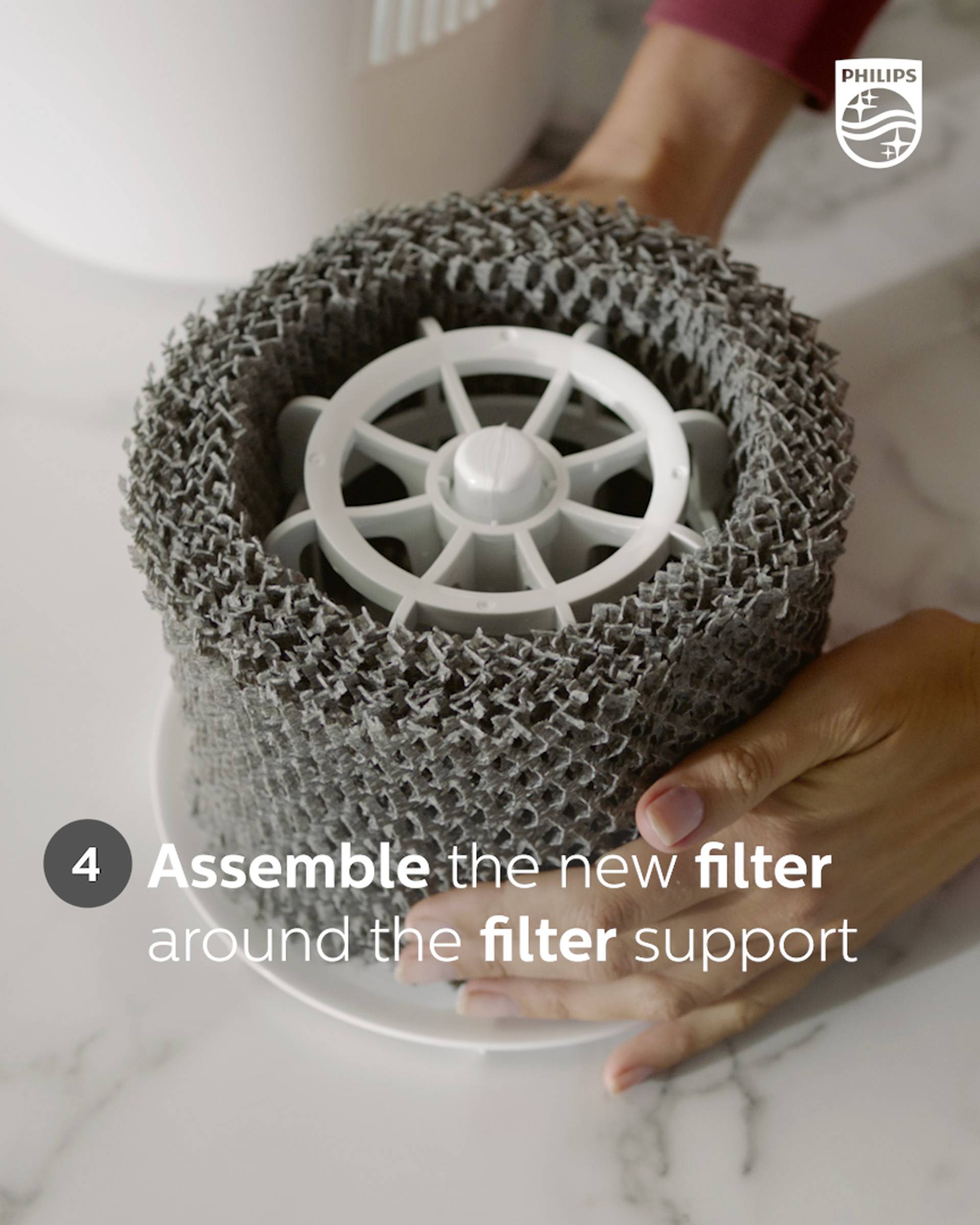 A person is mounting a grey filter onto a filter holder during step 4 of an air purifier process.