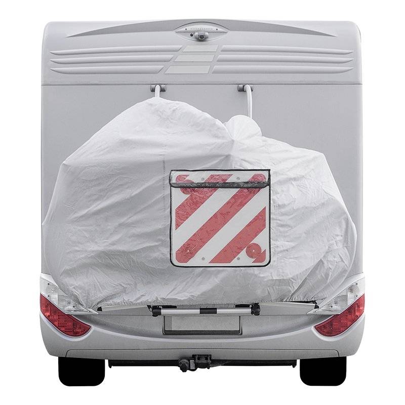 Rear view of a motorhome with a covered bicycle rack, red and white warning triangle visible.