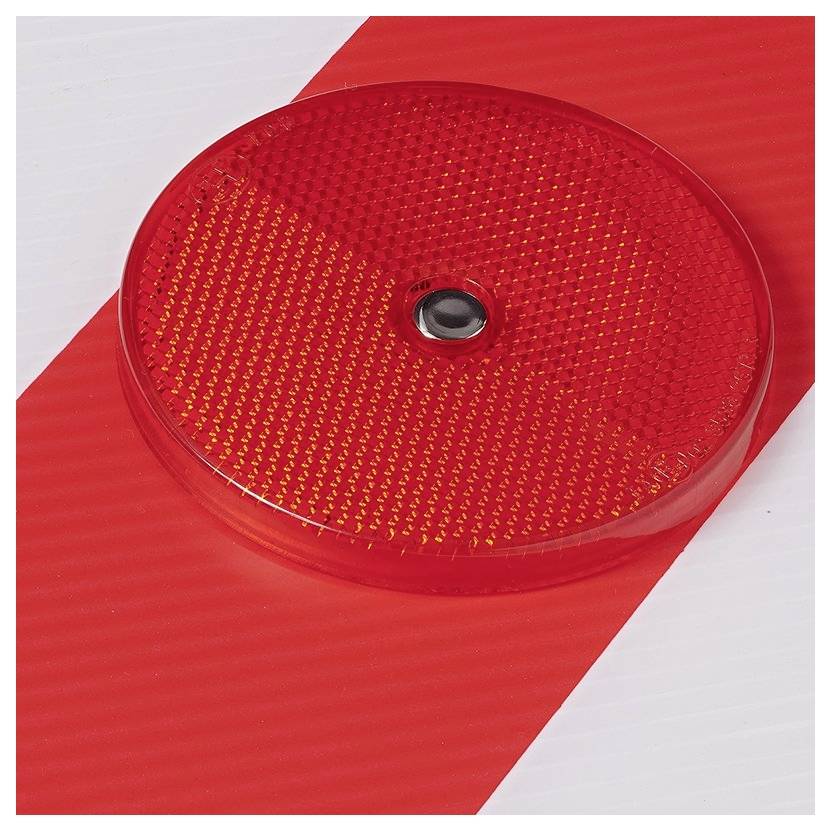 A round, red reflector on a red and white striped background, potentially serving as a warning or safety marker.