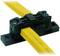 Yellow cable in a black cable clip, secured with two screws. Used for secure routing and fixing of cables.