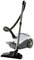 A white and grey vacuum cleaner with a long suction hose stands upright. Suitable for cleaning carpets and hard floors.
