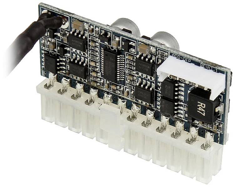An electronic circuit board with several black components and a white connector, presumably part of a technical device.