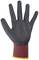 Black rubber work glove with red fabric and a yellow trim, shown from the front in an outstretched position.