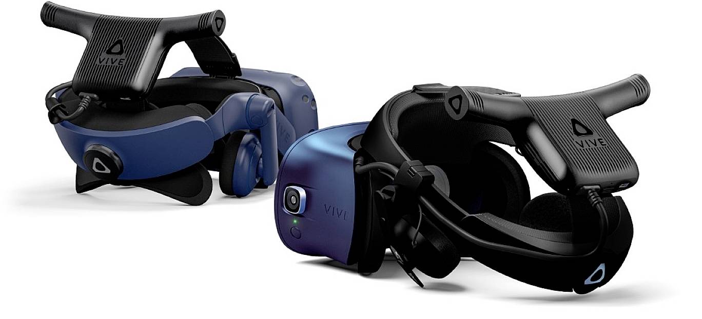 Two VR headsets are lying side by side. One is tilted slightly to the side, while the other is visible frontally. Marked with 'Vive'.
