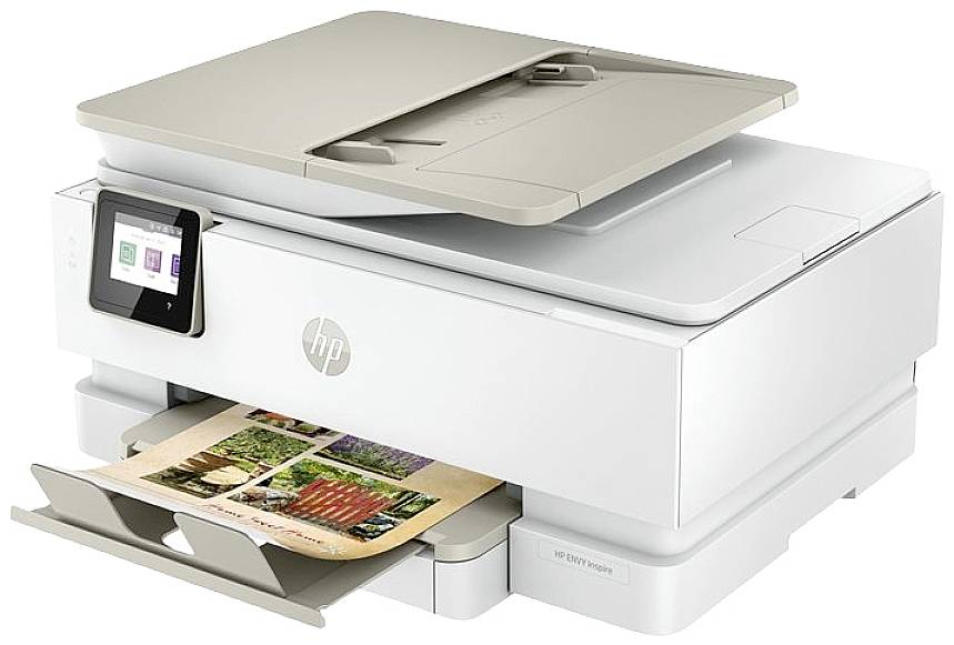 A white multifunction printer with a touchscreen, printing a document with colourful images.