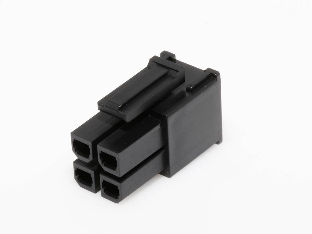 A black, four-pin electrical plug against a white background. The plug is arranged in a trapezoidal configuration.