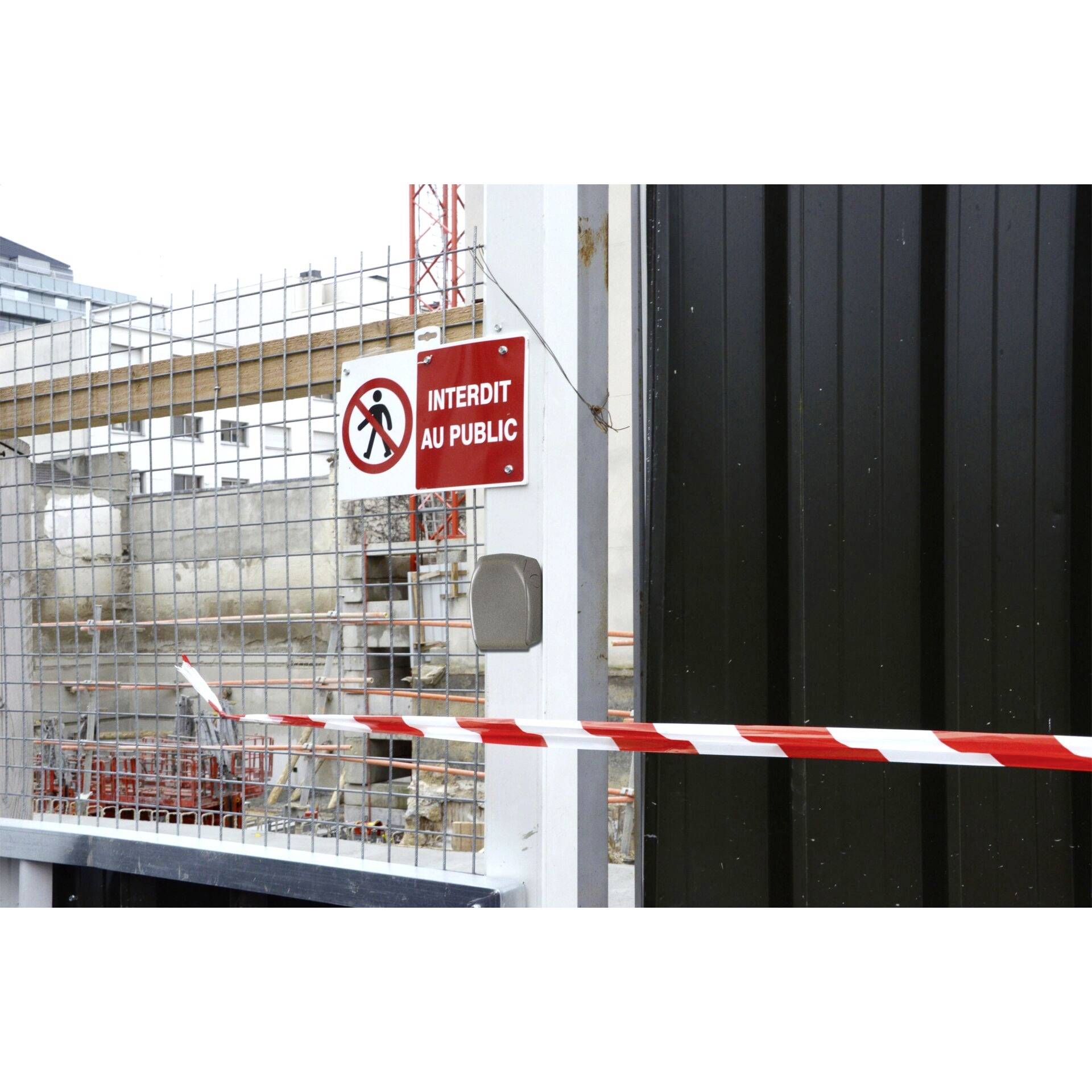 A construction site is secured by a red and white barrier tape. A sign 'No Public Access' warns against entry.