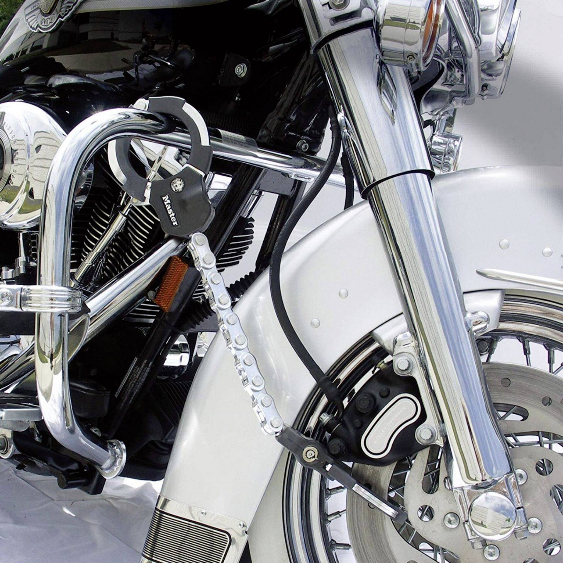 Motorcycle with a lock attached to the front wheel on the front fork. Safety advice for theft prevention.