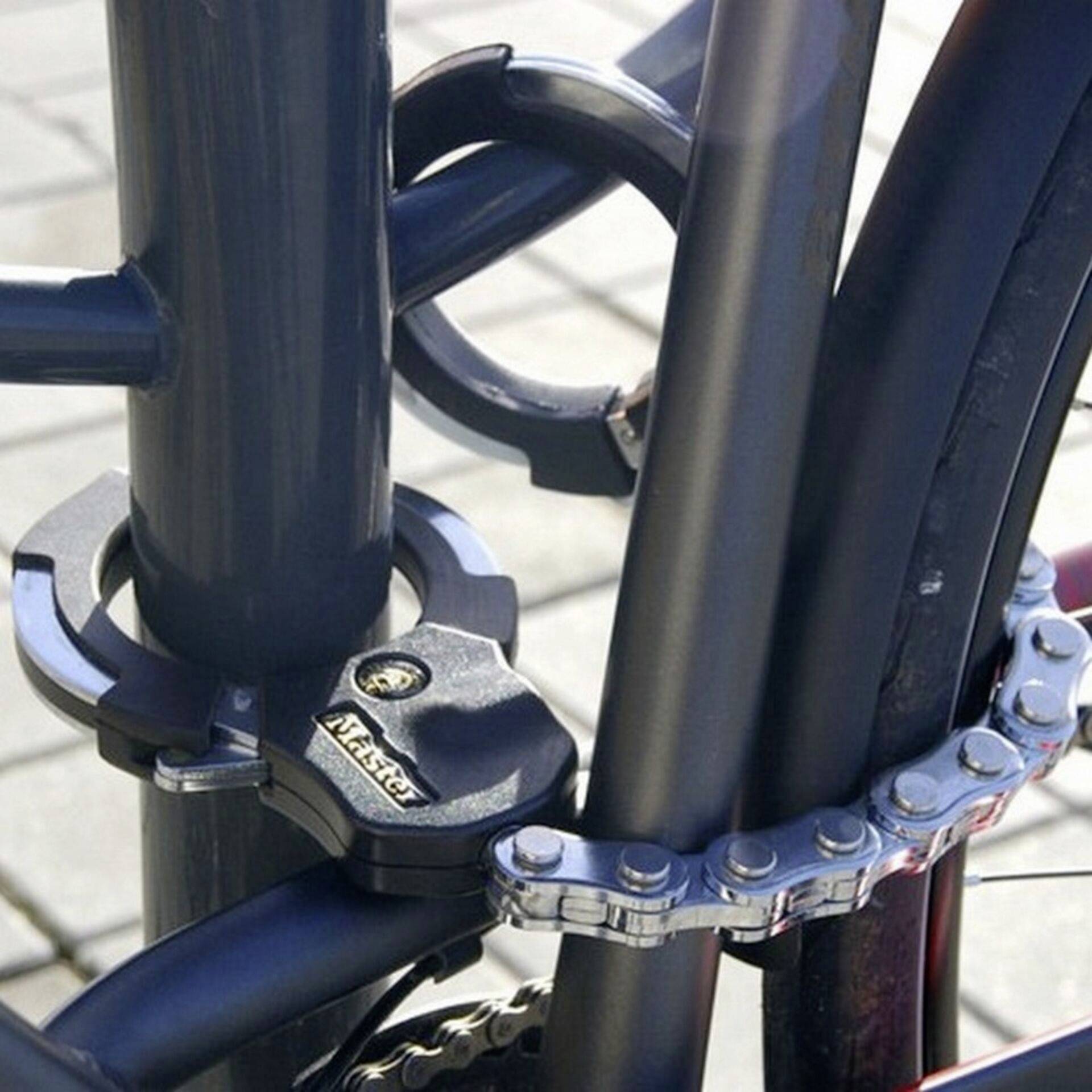 Bicycle secured with a robust padlock to a metal post, symbolising theft prevention and security.
