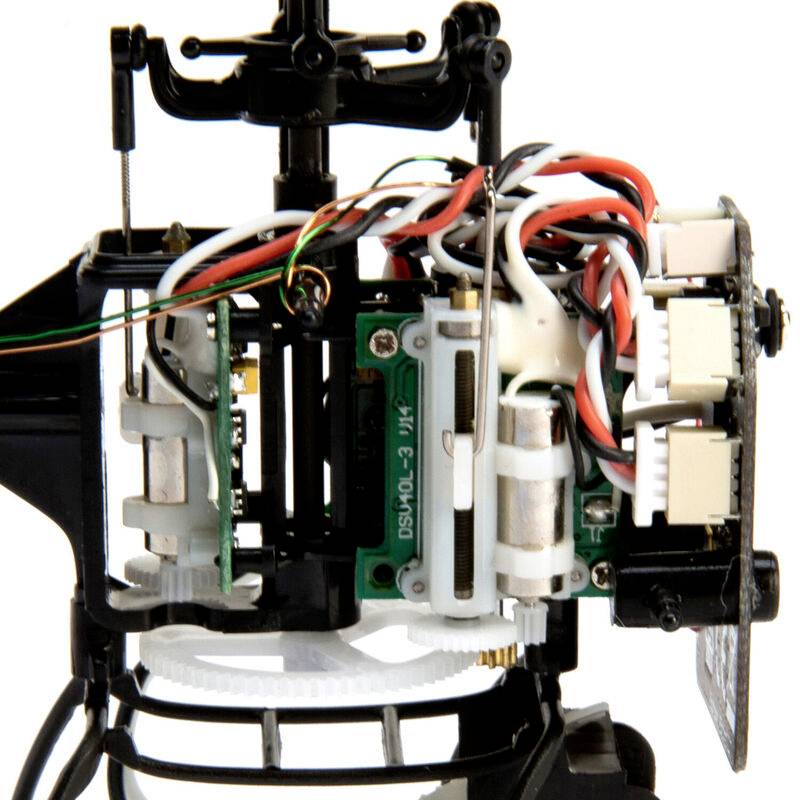 Close-up of a helicopter gearbox with visible gears, cables, and electronic components.