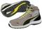 A pair of grey and black trainers with yellow laces and accents. The sole has a distinctive tread for better grip.