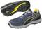 Sports shoe in blue with yellow and black accents, showing sole with non-slip tread and brand logo, side view.