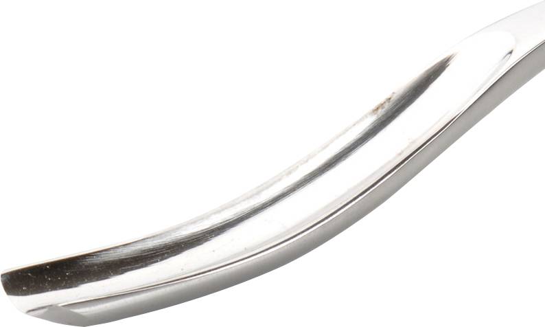 Silver metal spoon in close-up, showing curve and lustre.