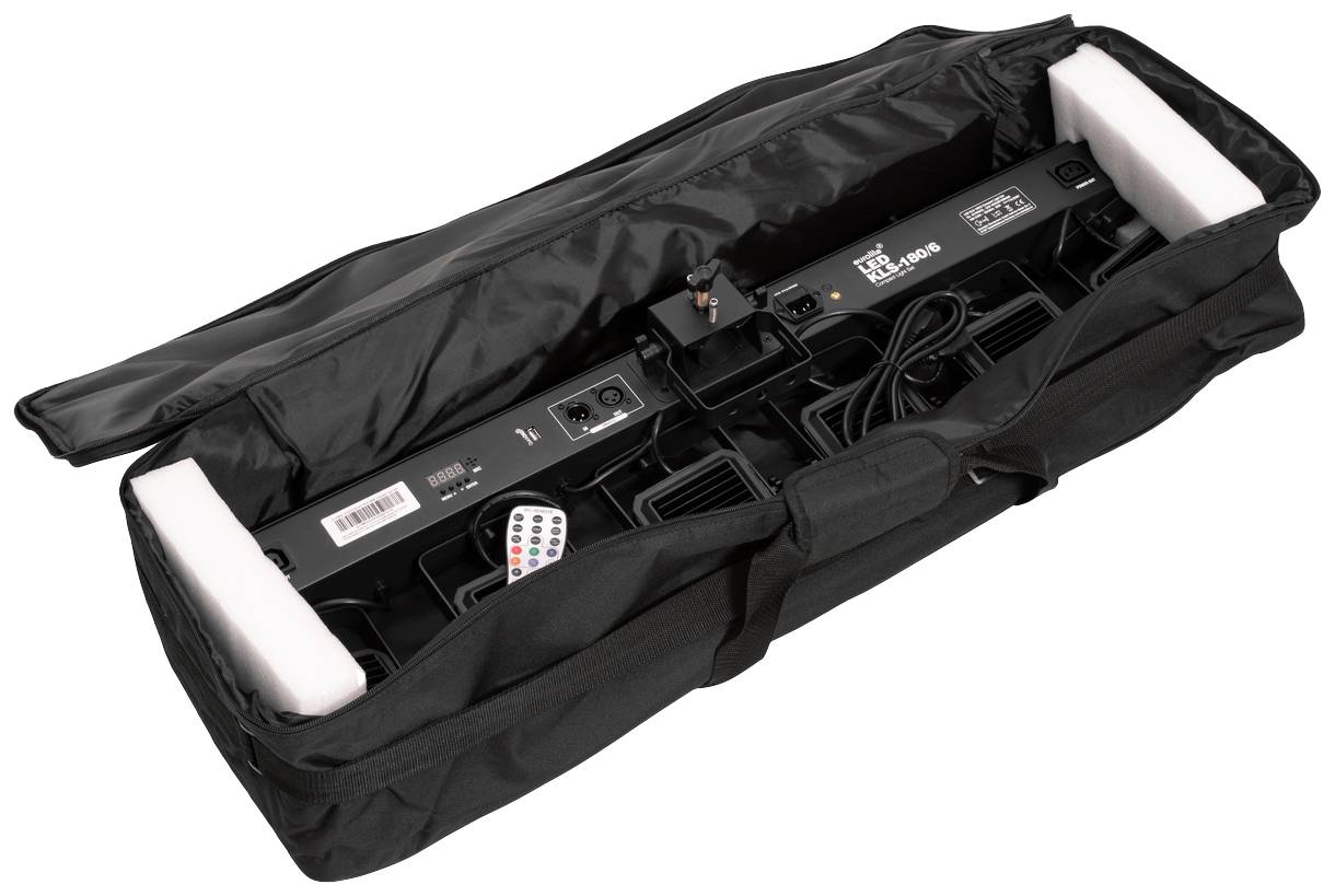 Carrier bag with an open zip reveals a lighting system featuring multiple spotlights and a remote control.