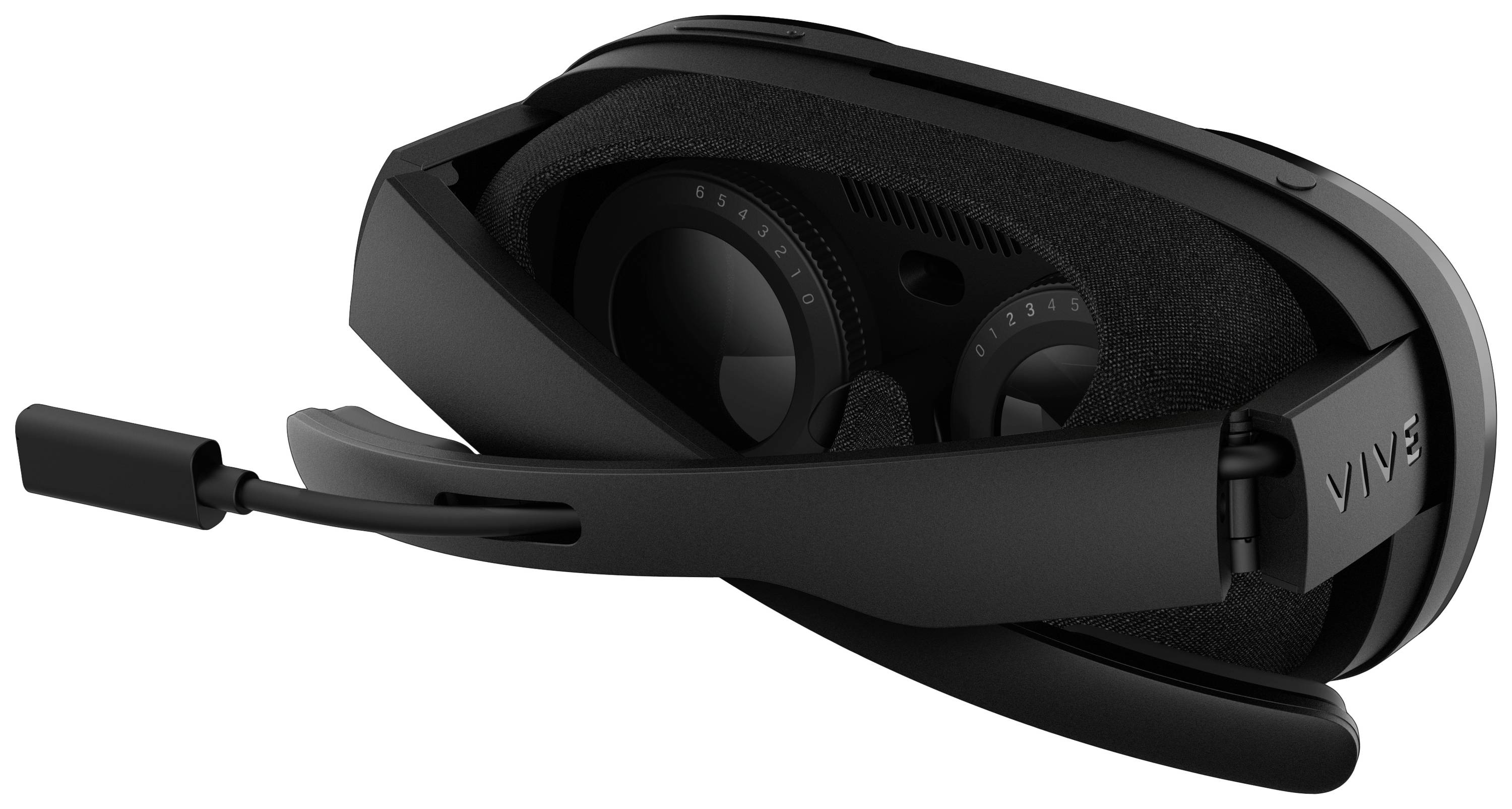 A black virtual reality headset lying on a table. It features a padded interior and an integrated headset.