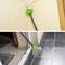 'Gutter Cleaning Tool: Telescopic Rod with Green Brush, Removes Leaves from Guttering, Illustrates Permeable Design.'