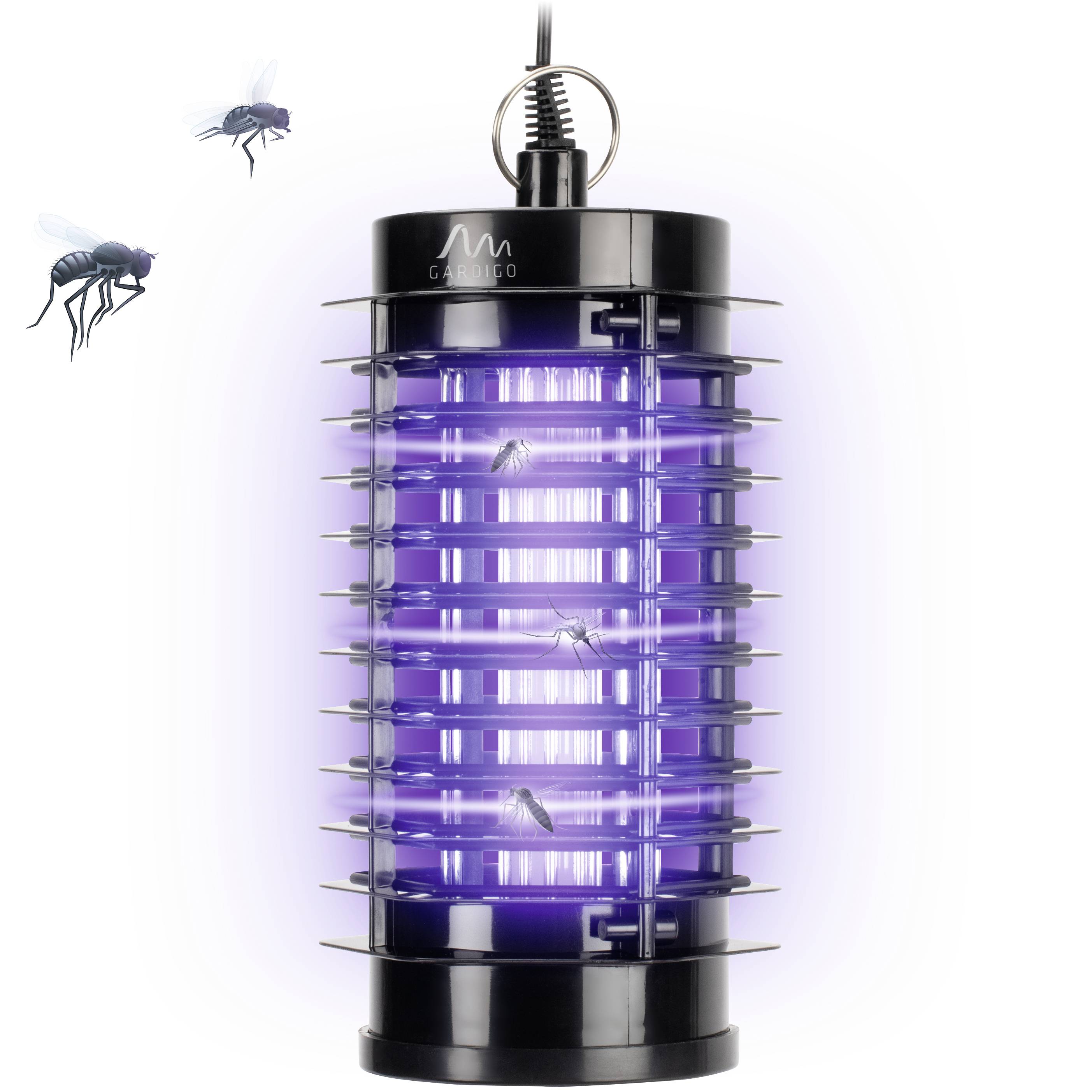 An electric insect killer with violet light attracts insects. Two flies are flying towards the device.