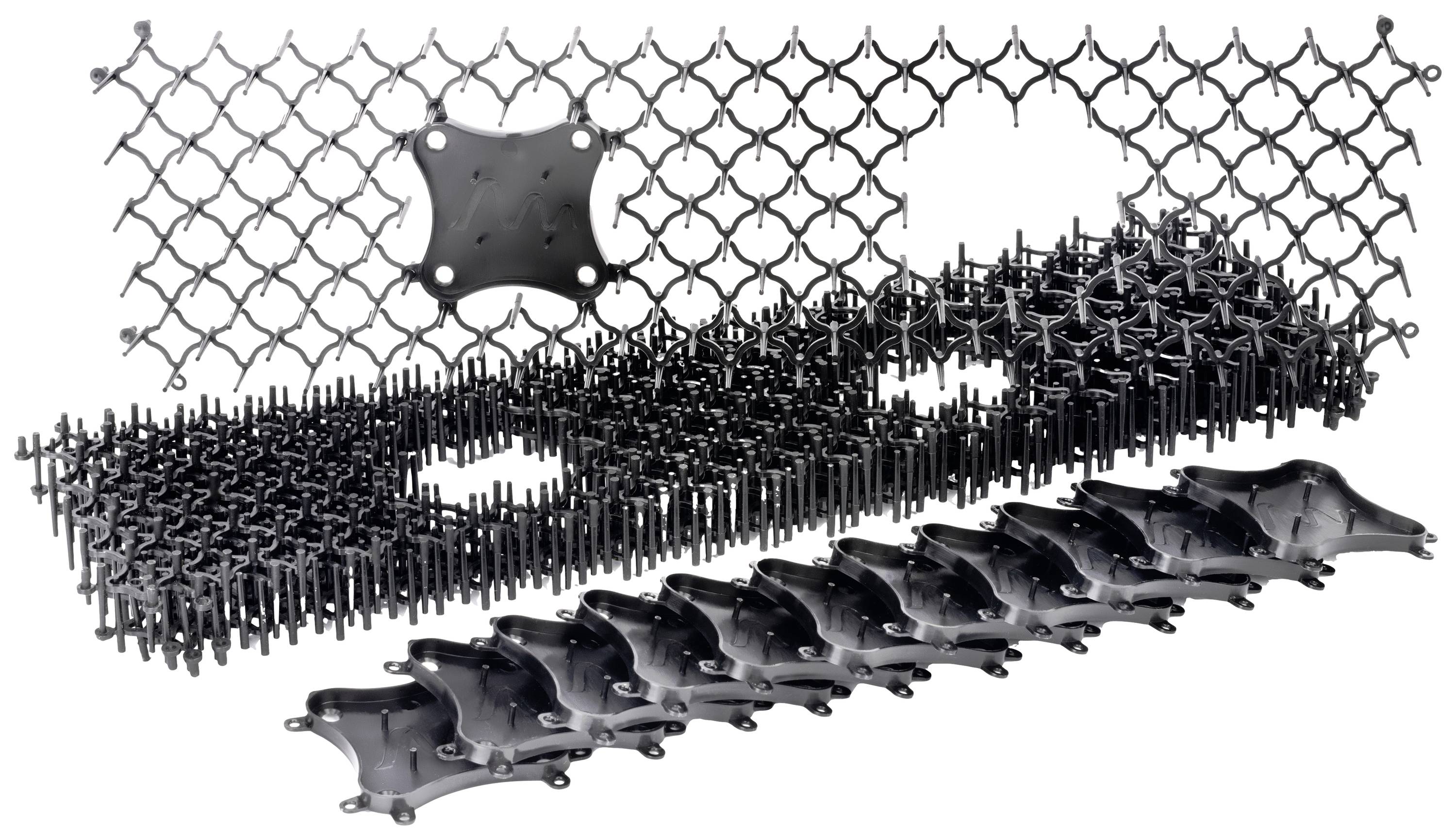 Black plastic structure with interlocking, diamond-shaped modules. Contains raised pins and a central fixing point.