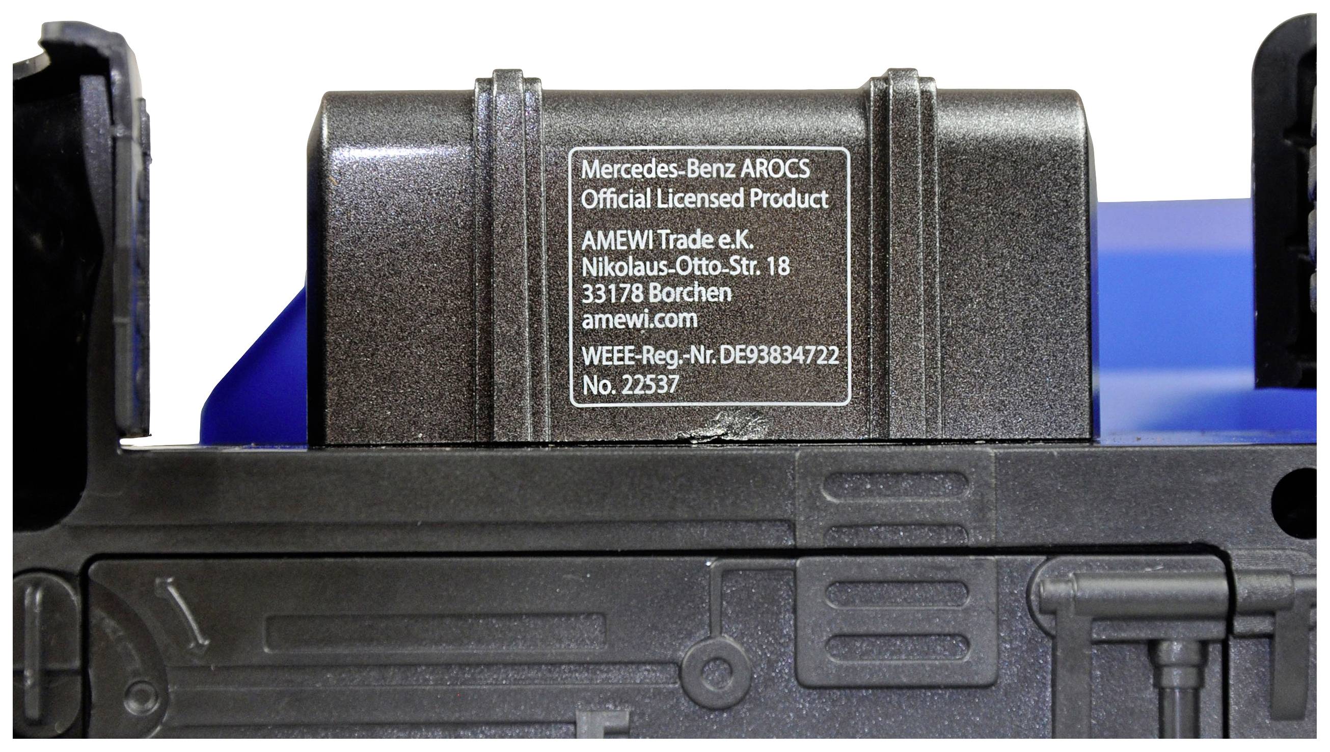Label on a model vehicle reading 'Mercedes-Benz AROCS, Official Licensed Product' with manufacturer details.