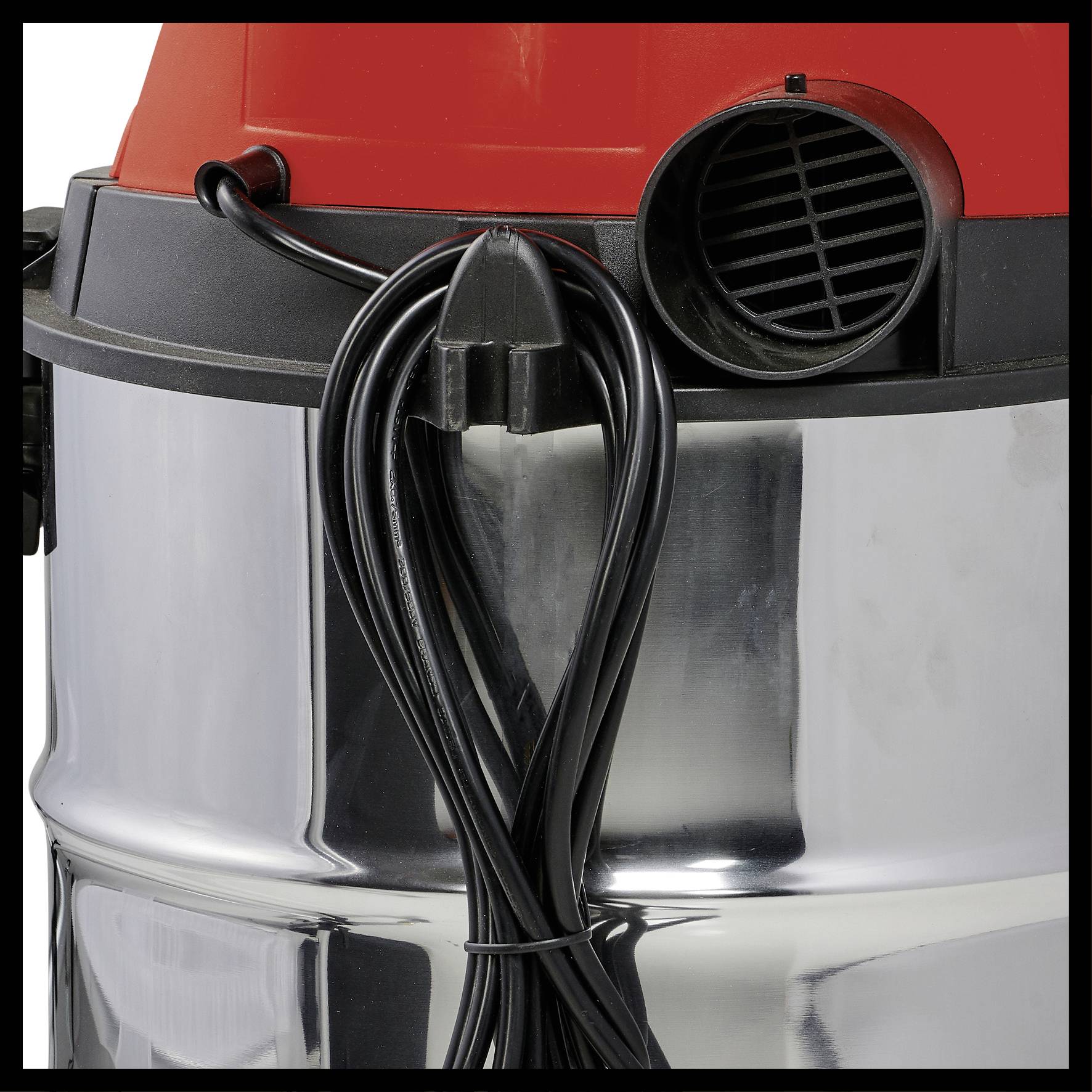 Industrial vacuum cleaner with a red head and silver body; power cable wound around the housing. Side view.
