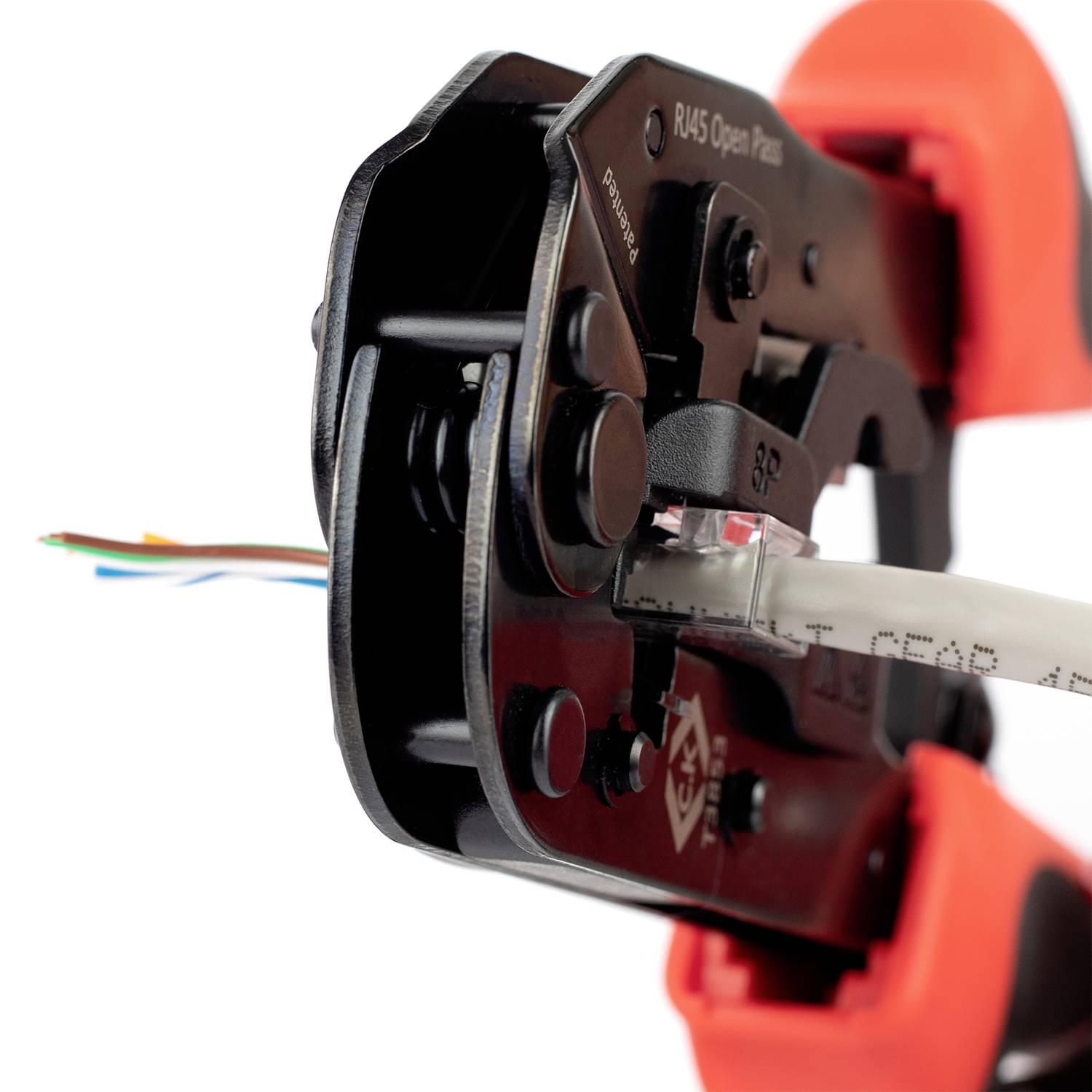 A crimping tool presses an RJ45 plug onto a network cable. Wires protrude from the pliers.